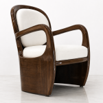Aureo accent chair three-quarter view showing curved mahogany frame and cream upholstery