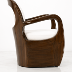 Close-up side view of Aureo accent chair glossy wood arm and cream cushion