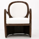 Aureo accent chair front view with rounded mahogany frame and white cushions