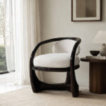 Modern solid mahogany wood accent chair with white upholstered seat in minimal living room setting
