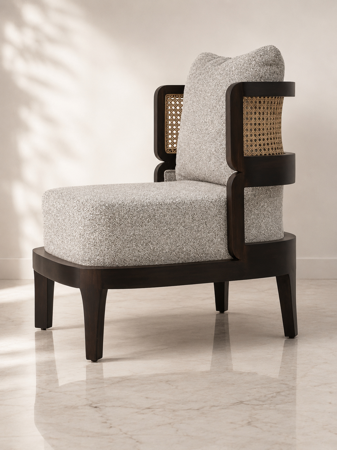 Veena accent chair angled view with boucle cushions and cane back panel