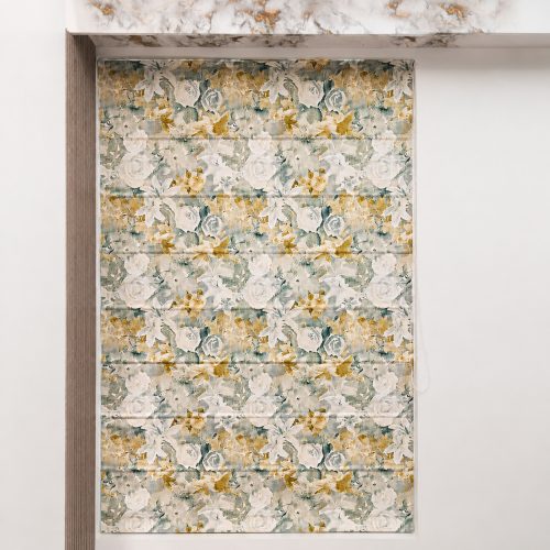 Floral roman blind in sage and mustard rose print above a marble-topped alcove