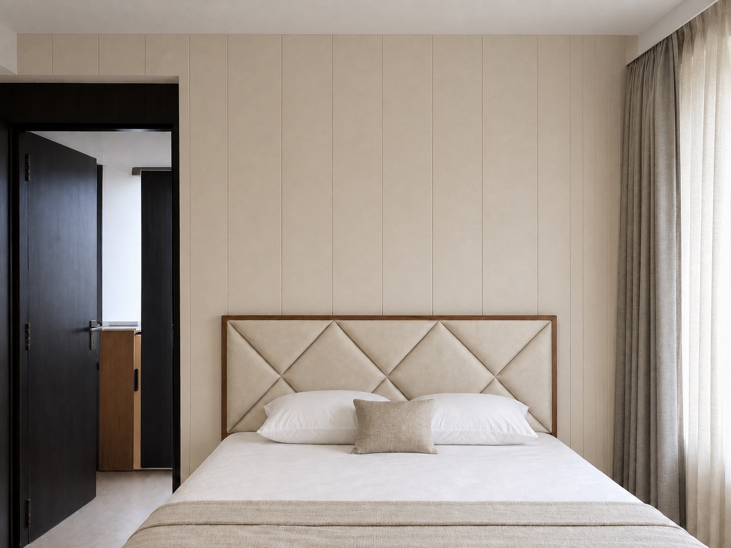 Ivory diamond panel padded headboard with grey curtains in a Kolkata bedroom designed by Avikar