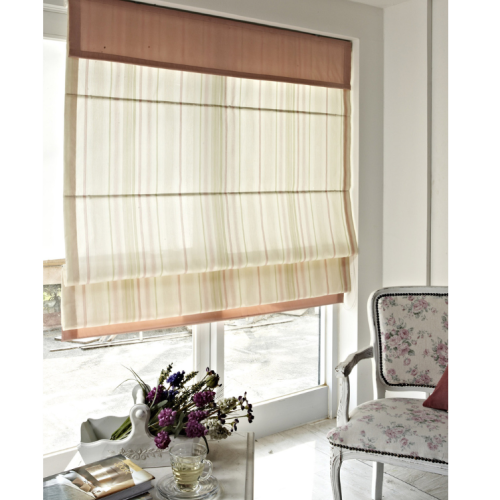 Striped roman blind in a cozy reading nook with a floral armchair