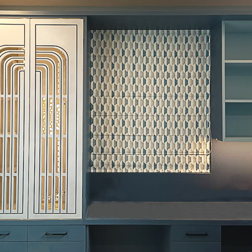 Geometric honeycomb-pattern roman blind in a navy blue built-in cabinet wall