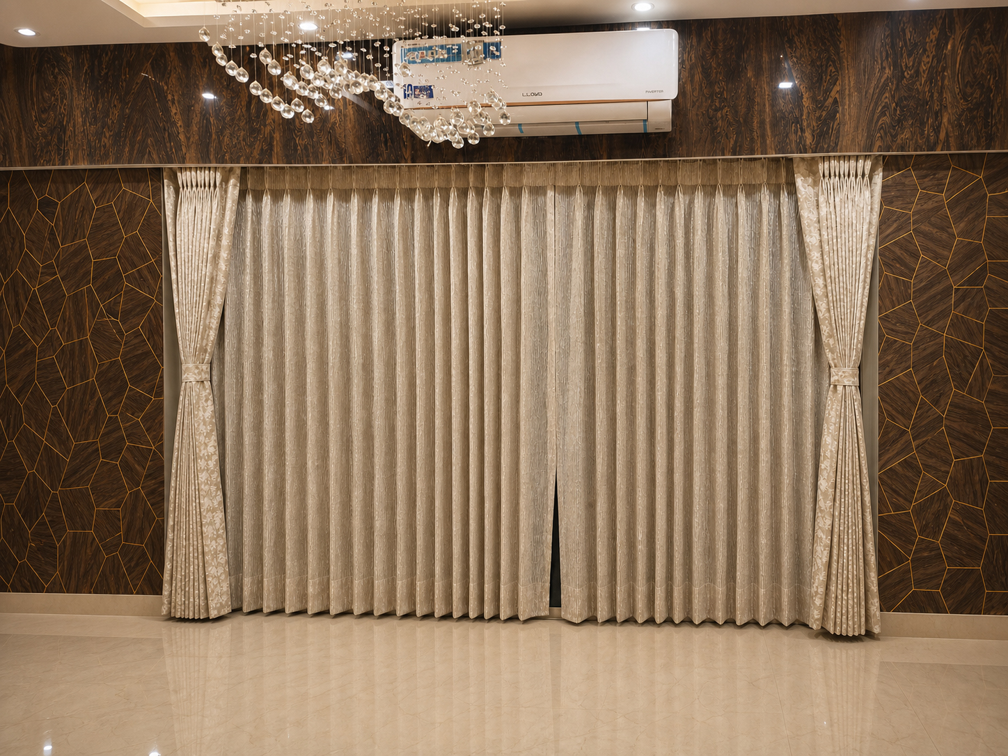 Champagne pleated sheer curtains tied back in a wood-panelled Kolkata living room