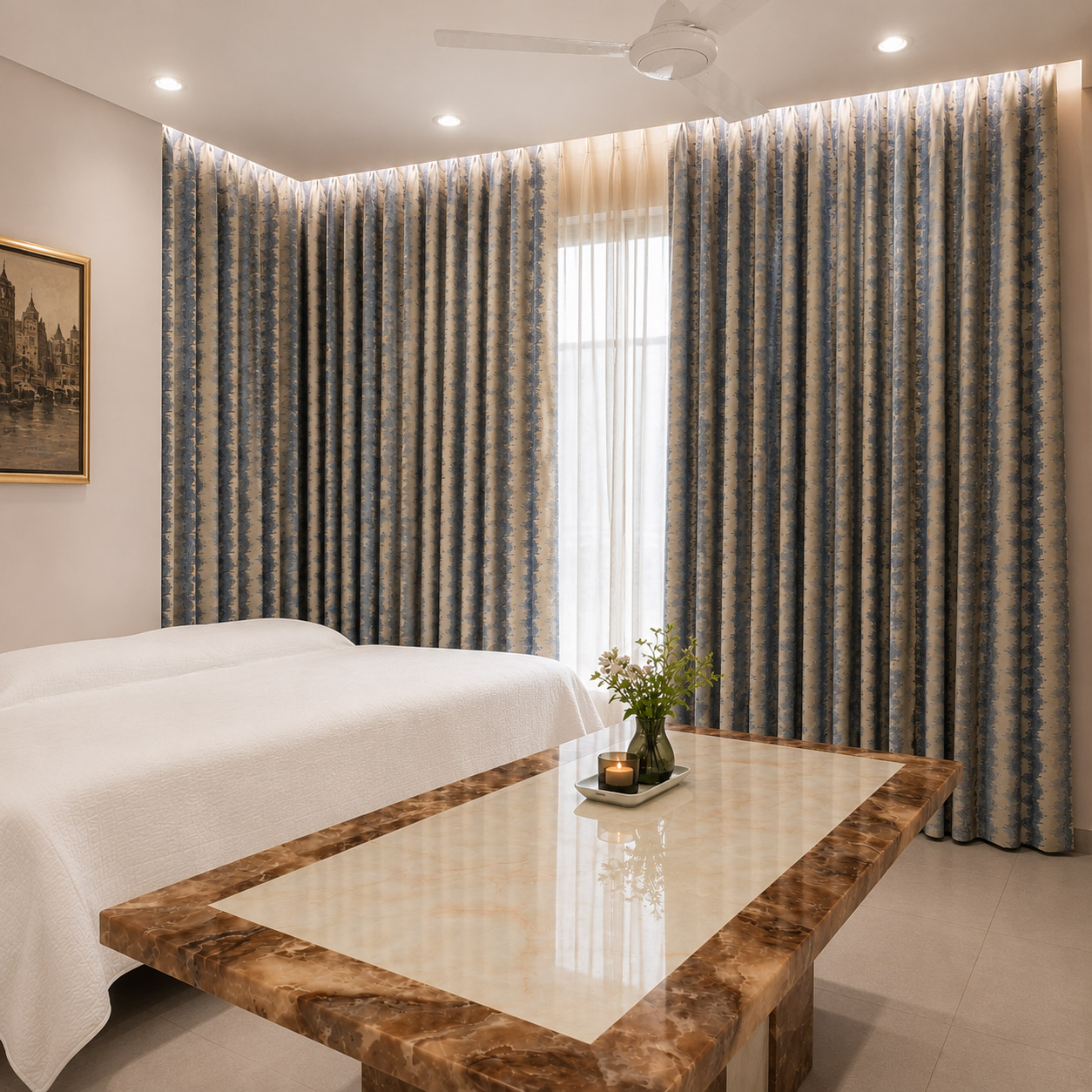 Blue and beige damask curtains with cove ceiling lighting in a living room
